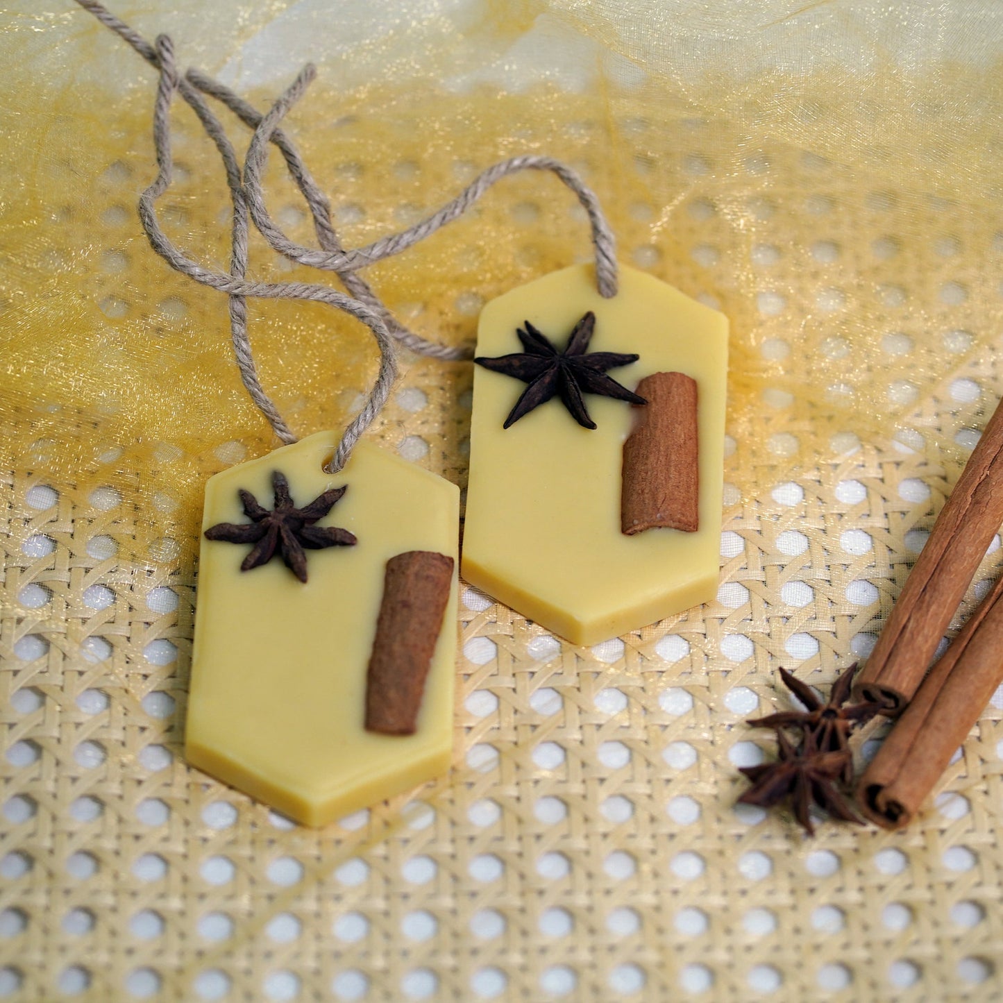Beeswax Tablets with cinnamon sticks and star anise on a textured surface