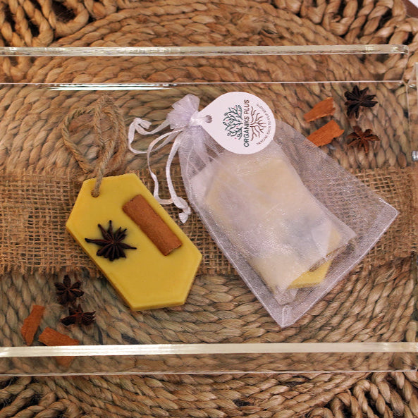 Clear glass tray with beeswax-scented tablets on a brown woven mat
