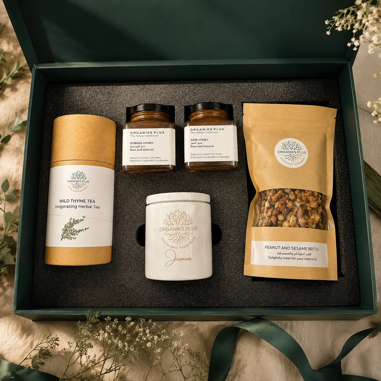 Organiks Plus Gift set with tea, honey, and snack mix in a decorative box.