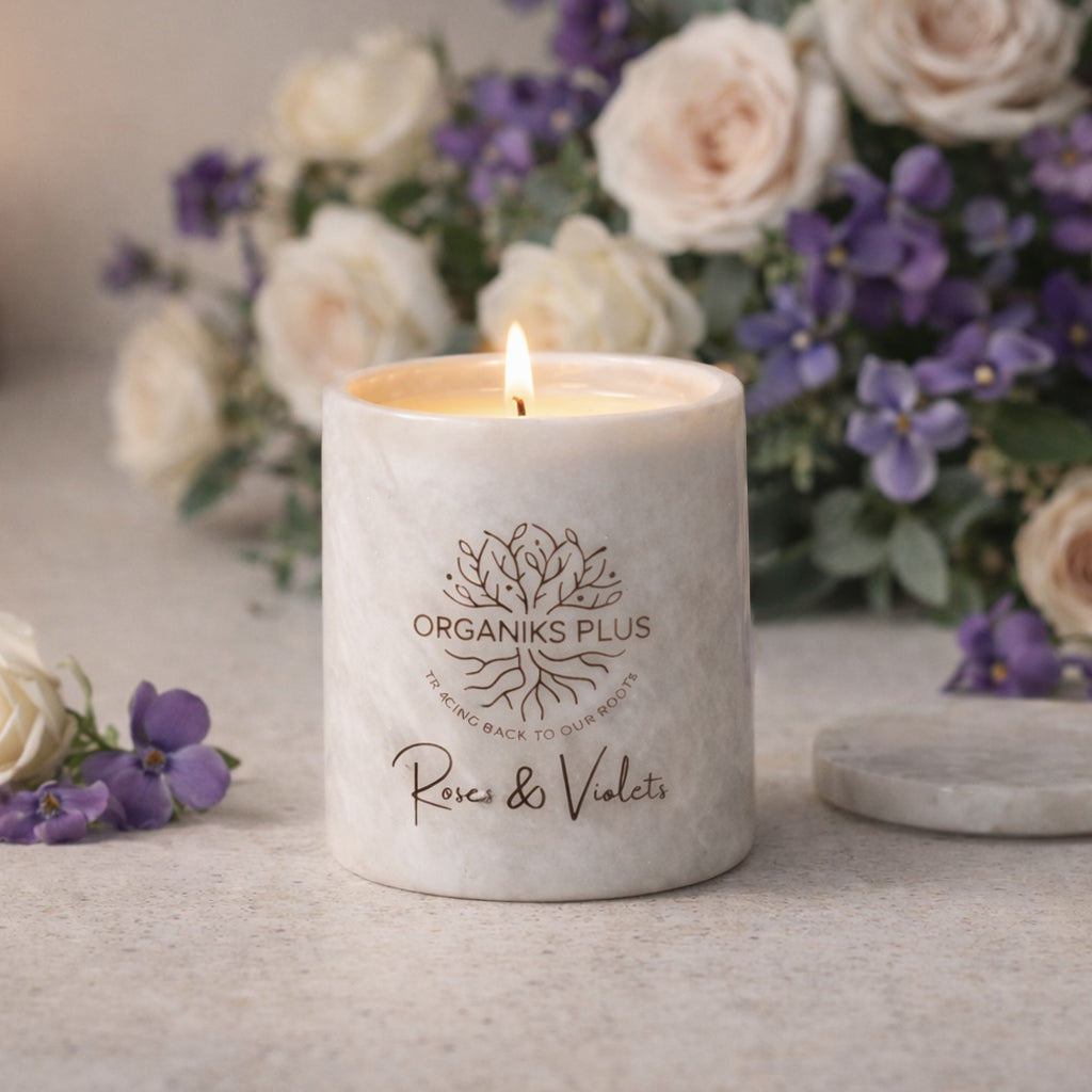 Marble Candle with 'Organiks Plus' branding in front of flowers