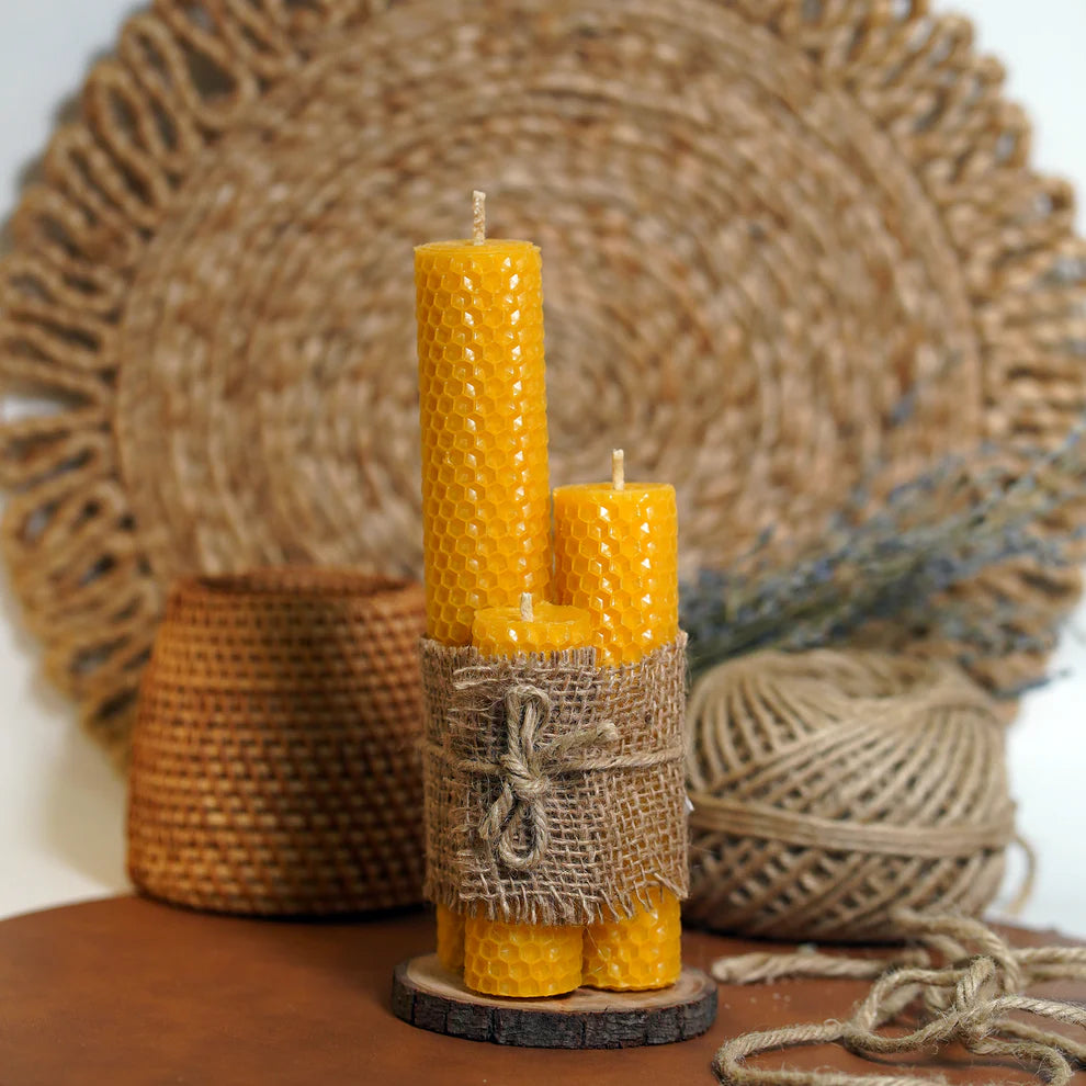 Hand-rolled beeswax dinner candles set of 3 by Organiks Plus with warm golden glow.