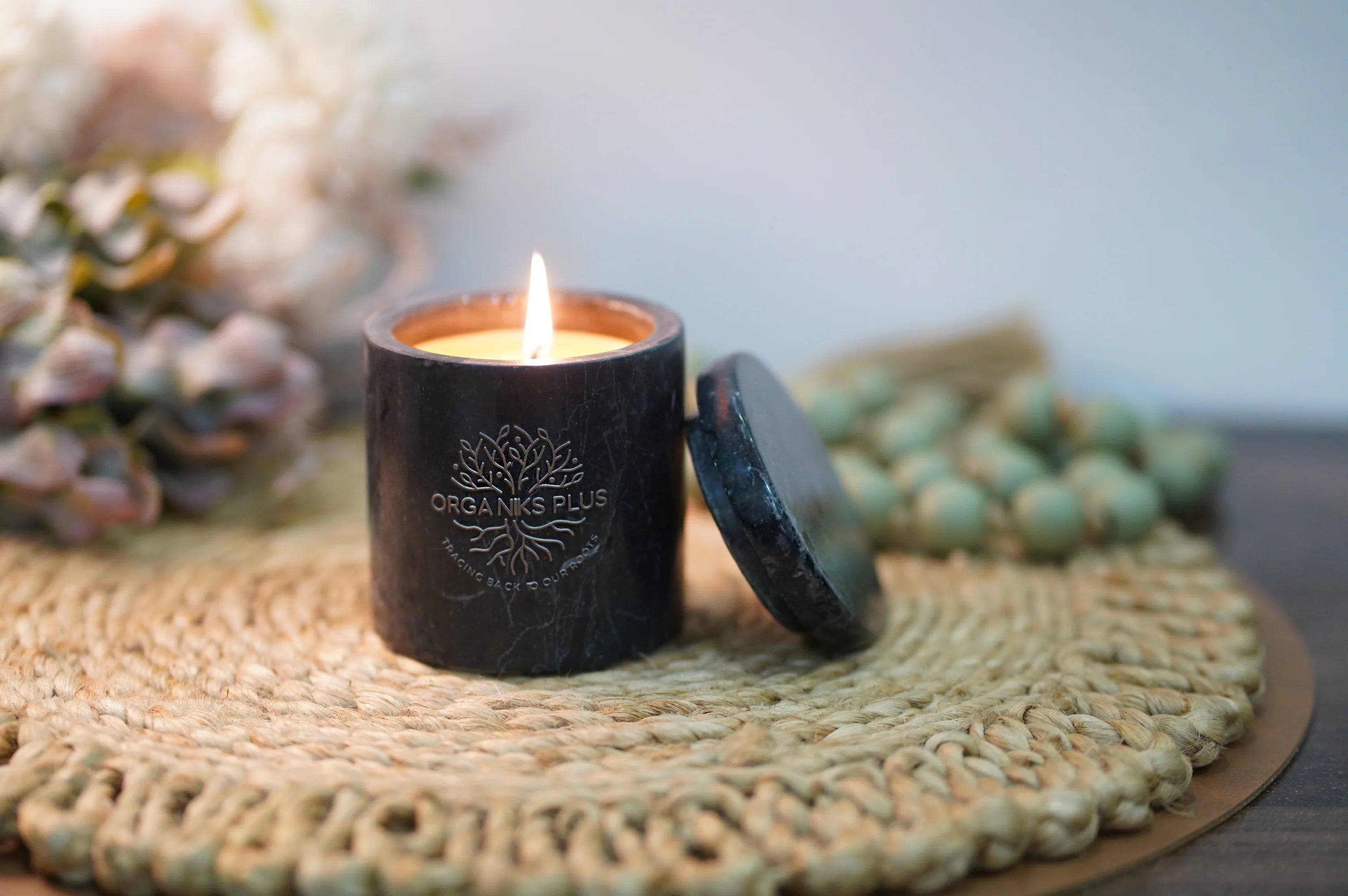 Organiks Plus beeswax scented candle glowing warmly – melt away stress and light up happiness.