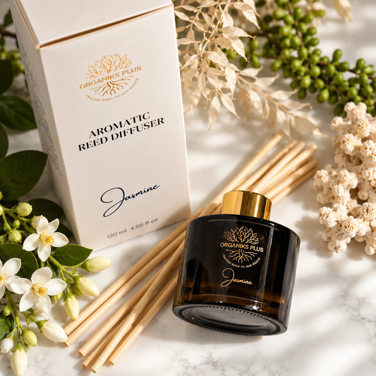 Organiks Plus Jasmine reed diffuser 120 ml flat lay with gold-ring bottle, presentation box, reed sticks and jasmine flowers