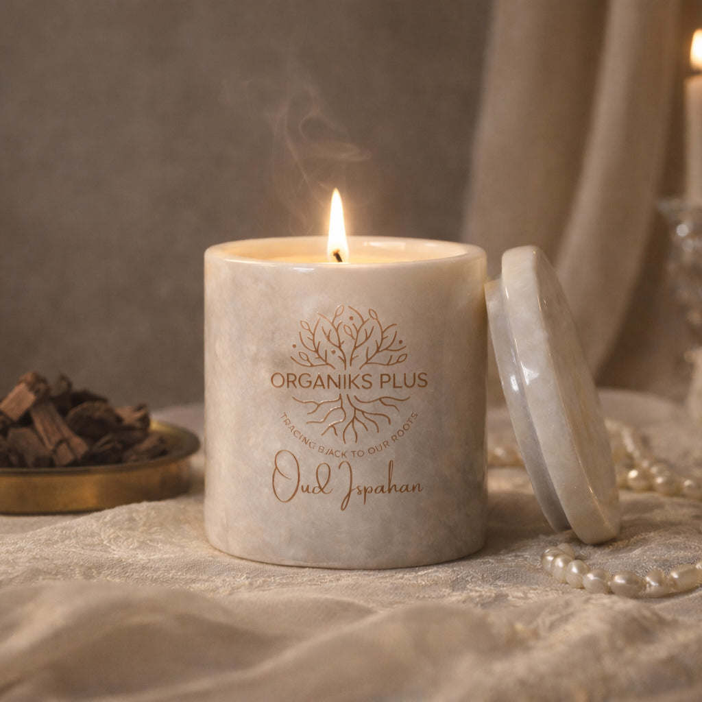 Candle with 'Organiks Plus' branding on a textured surface
